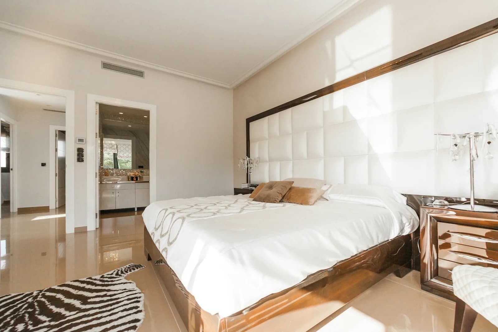 Bedroom suite with statement headboard and warm lighting